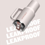 Stainless steel tumbler with 'Stanley' branding on a light pink background with 'LEAKPROOF' text.